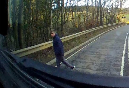 A dashcam image of the man walking away after the accident.