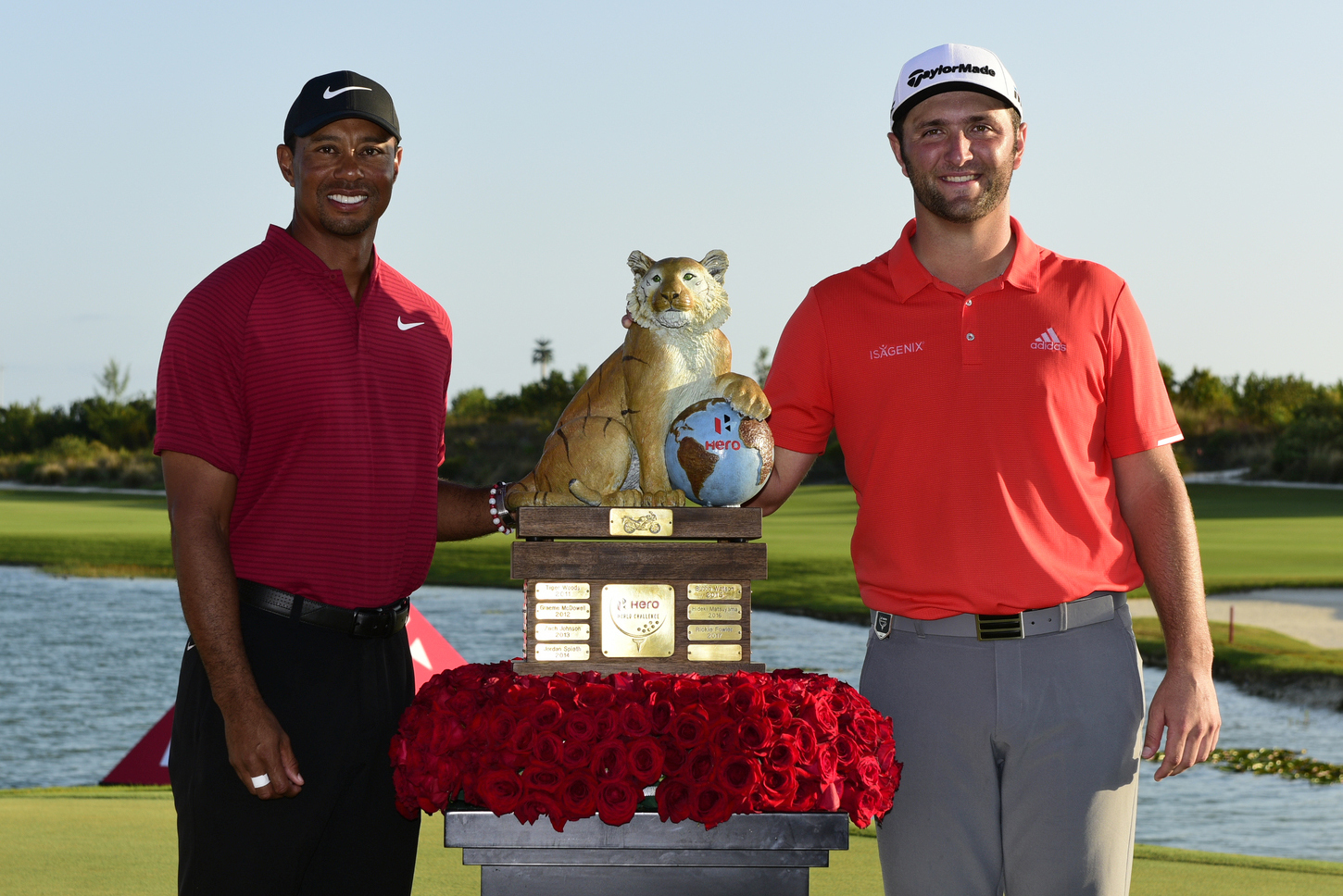 Spain's Jon Rahm, right, poses with host Tiger Woods after winning the Hero World Challenge.