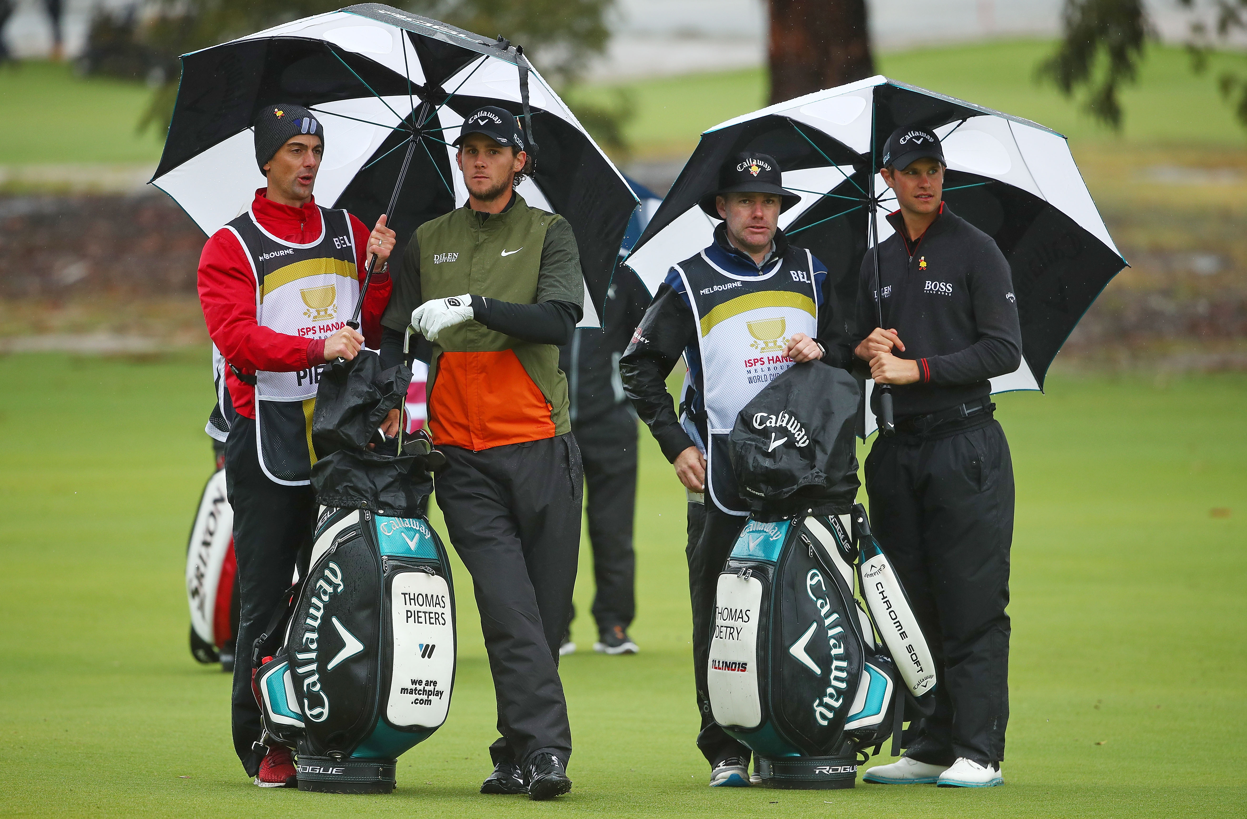Thomas Detry (Right) and caddy Ryan McGuigan (Second from Right) with Thomas Pieters of Belgium and his caddy  talk on the 9th hole during day two of the 2018 World Cup of Golf at The Metropolitan on November 23, 2018 in Melbourne.