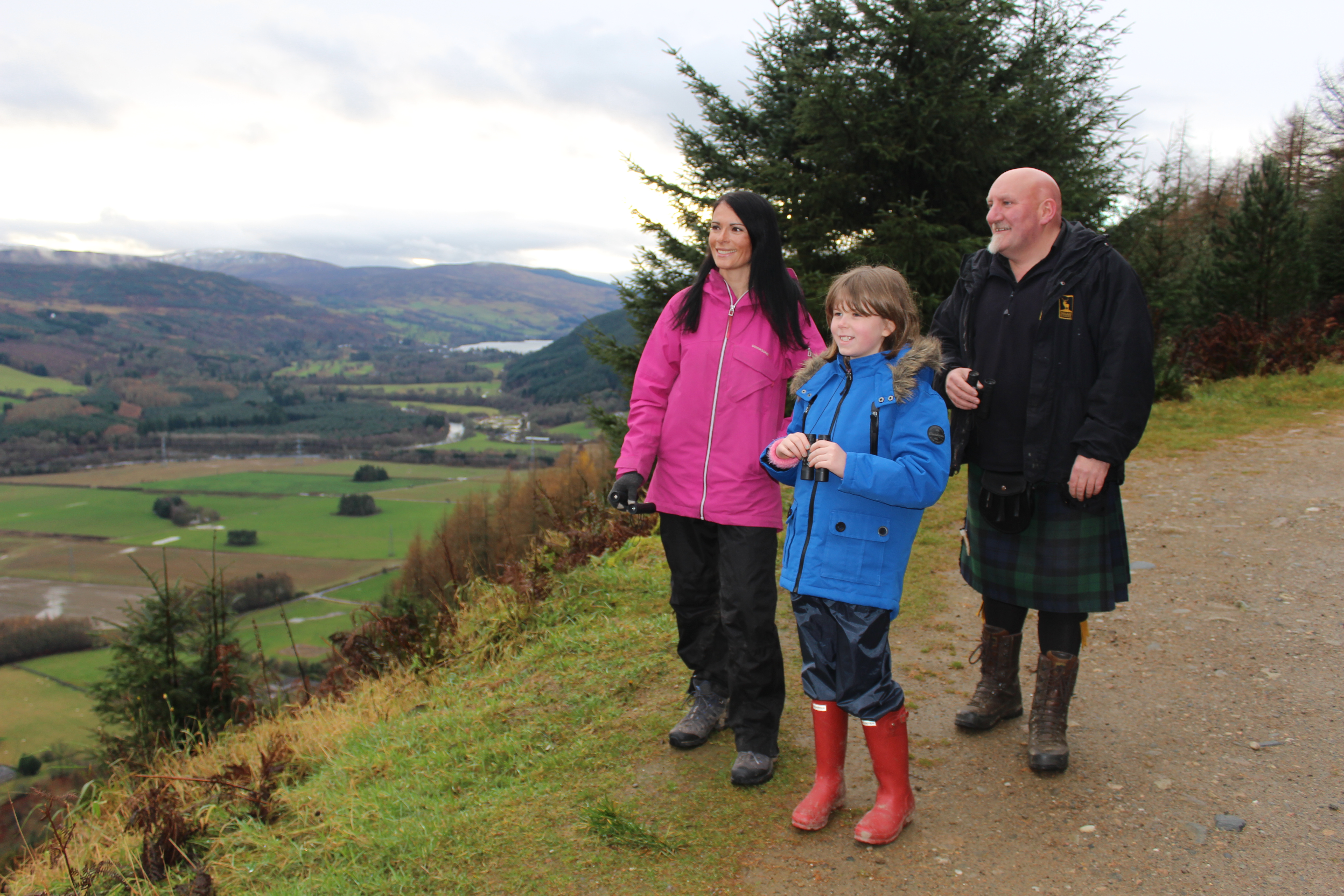 Gayle Ritchie, Deia Wilkinson and Highland Safari Winter Watch guide Jim Scotland gaze out over Strathtay Valley.