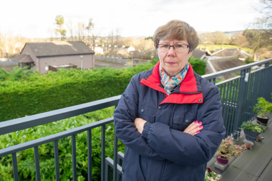 Morag McPherson on her balcony looking over the proposed area of the Gospel Hall which is to be developed.