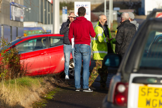 Workers gather outside the HES plant in Dundee