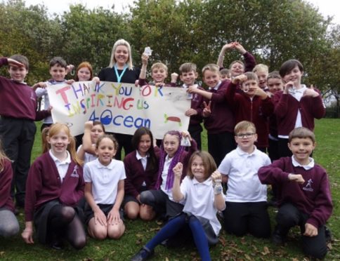 Northmuir P5 teacher Nikki Paterson with pupils and the 4Ocean bracelets they received