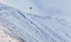 A Coastguard Search and Rescue helicopter searches Ben Nevis for missing climbers in 2018.