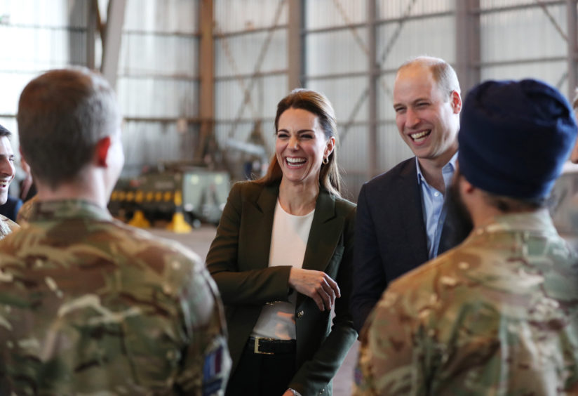 The Duke and Duchess of Cambridge meet members of 31 SQN and other operational personnel in a hangar at RAF Akrotiri in Cyprus. Andrew Matthews/PA Wire