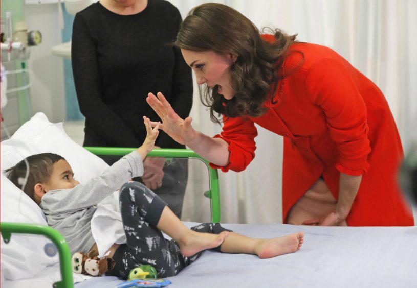 The Duchess of Cambridge with four year old Rafael Chana as she officially opens the Mittal Children's Medical Centre during a visit to Great Ormond Street Hospital. Frank Augstein/PA Wire