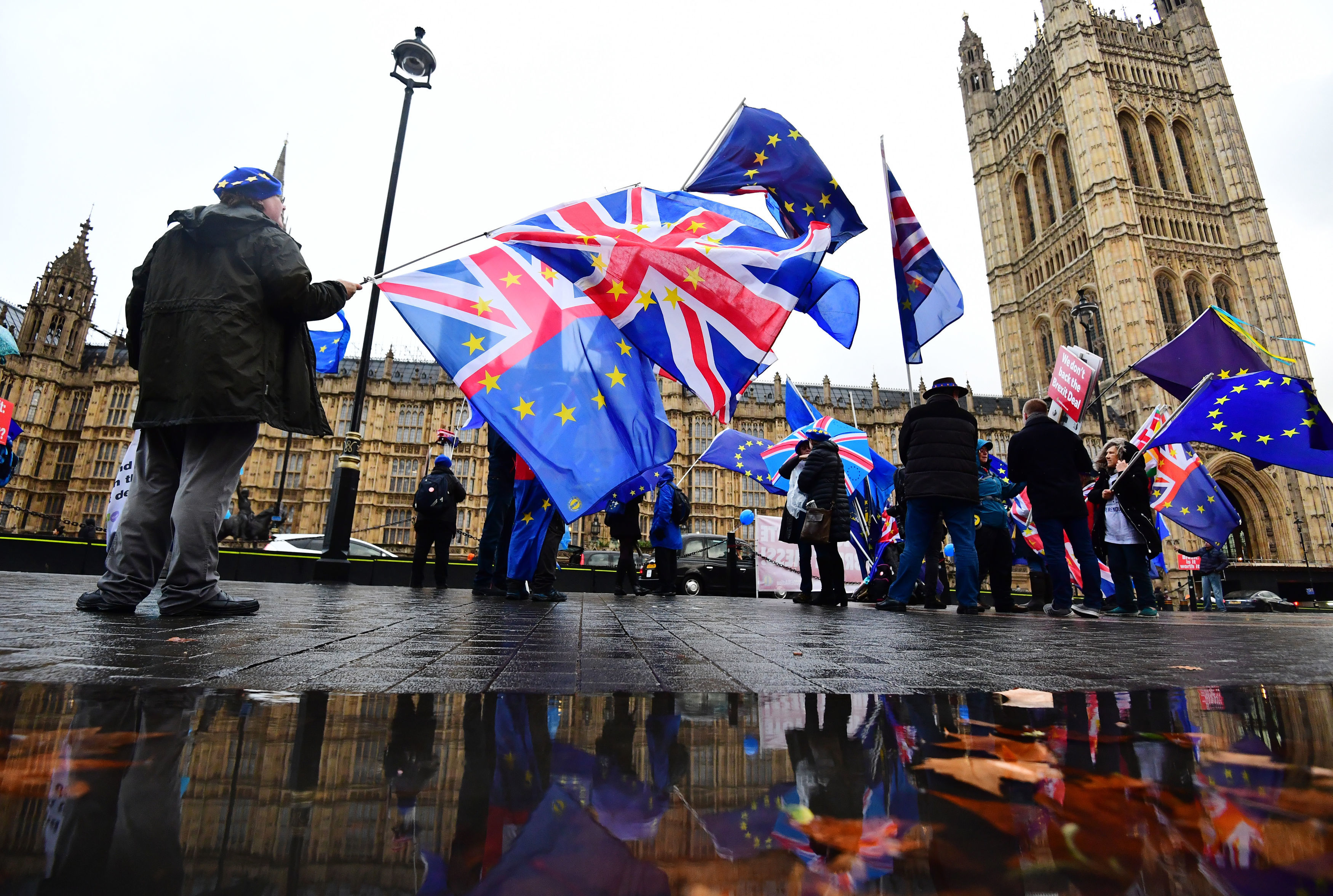 Anti-Brexit campaigners with Union and European Union flags outside the House of Commons in London.