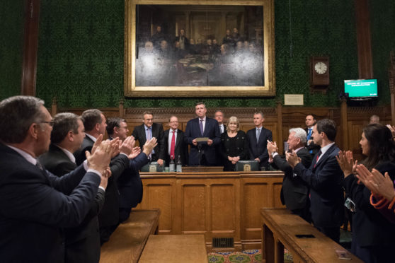 Sir Graham Brady (centre), chairman of the 1922 Committee, announces that Theresa May has survived an attempt by Tory MPs to oust her as party leader with a motion of no confidence at the Houses of Parliament in London.
