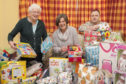 Irene Gillies MBE, Kathleen Strachan and Paul Cassidy from Tescos in Brechin with some of the toys.