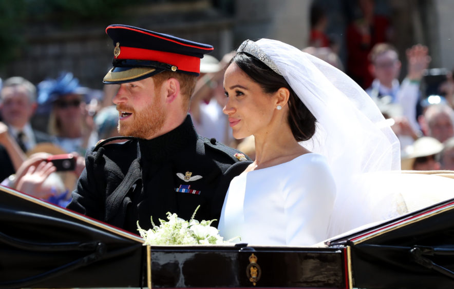 Meghan Markle and Prince Harry in a carriage following their wedding in 2018