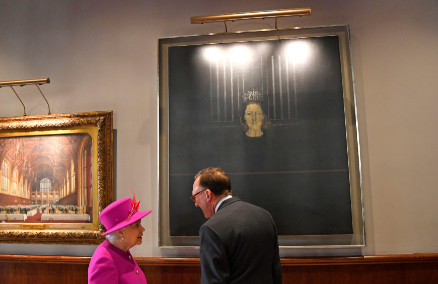Queen Elizabeth II, looks at a portrait of Princess Margaret, during her visit to The Honourable Society of Lincoln's Inn in London to officially open its new teaching facilit.