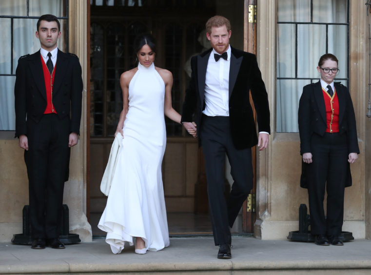 The newly married Duke and Duchess of Sussex, Meghan Markle and Prince Harry, leaving Windsor Castle. Steve Parsons/PA Wire