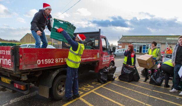 Volunteers help distribute food donated last year