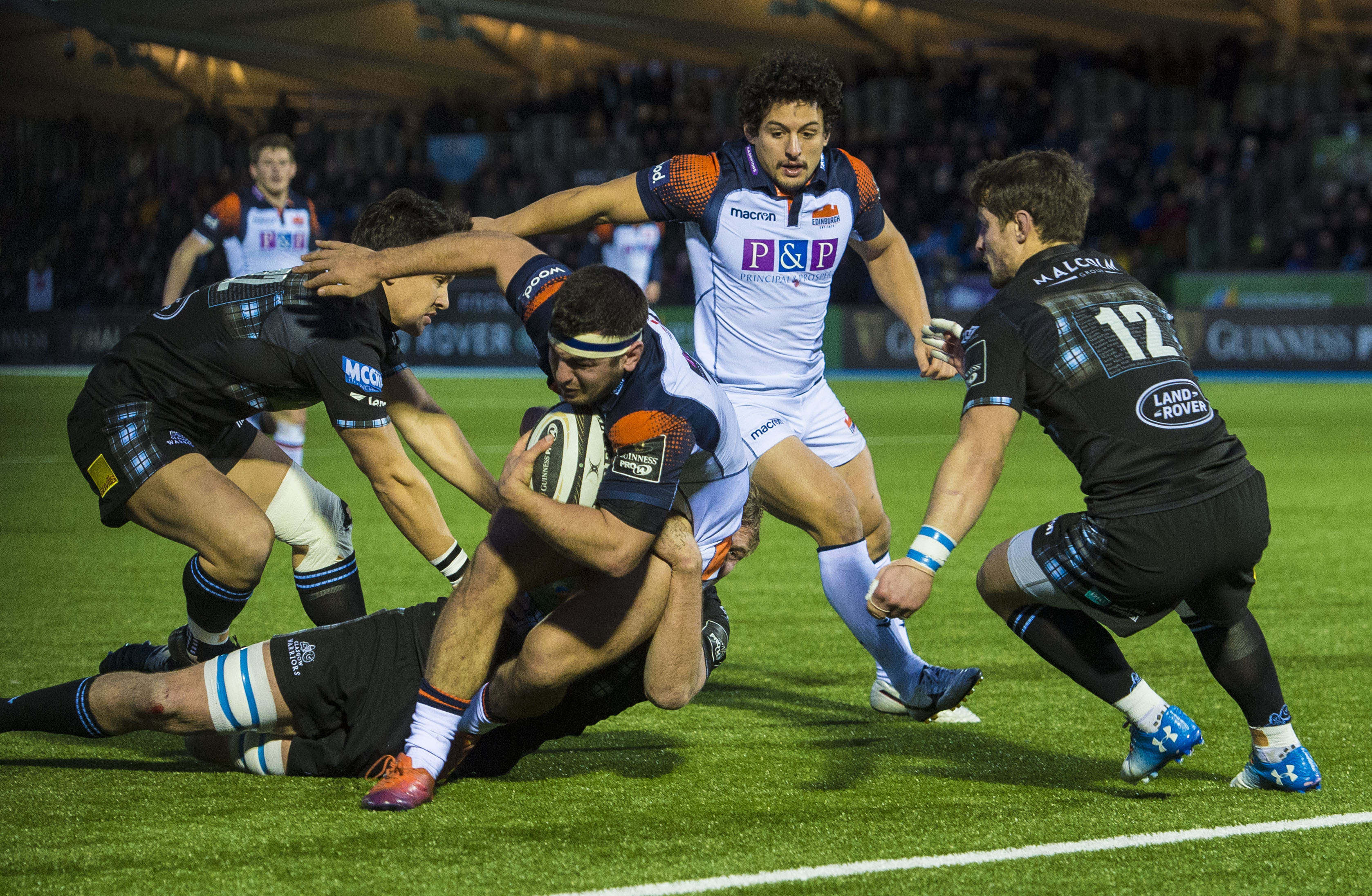 Stuart McInally spins out of a tackle to score Edinburgh's try in their 16-8 win over Glasgow at Scotstoun.