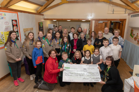 Avril Dullea presents cheque to Rose Duncan from the cafe attended by 89th North Glen Scouts group and local councillors and people who will benefit from the donation