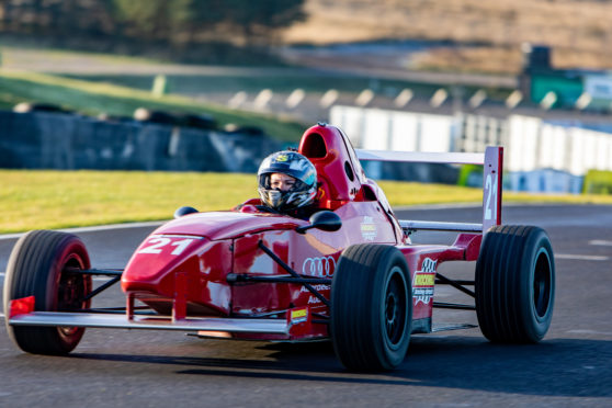 Gayle roars around the race track at Knockhill in a Formula Race Car.