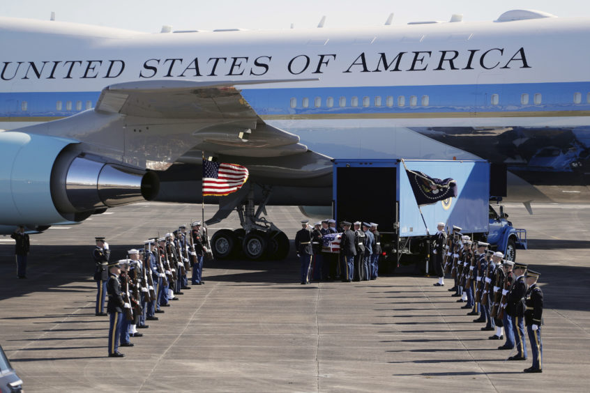 The remains of President George H.W. Bush are loaded onto Special Air Mission 41 by a military honor guard before flying to Washington D. C. on December 3, 2018 in Houston, Texas.