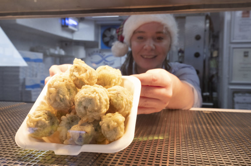 Chelsea McGowan with a portion of deep-fried brussels sprouts.