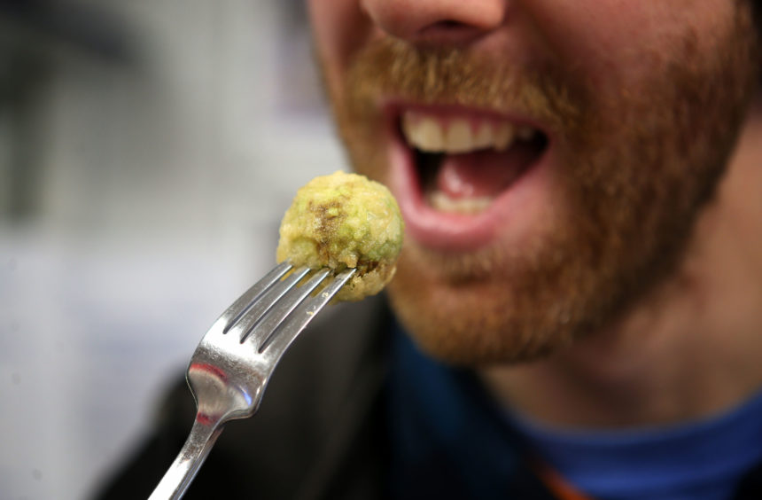 Customer Robert Gray, from Crieff, samples a deep-fried brussels sprout.