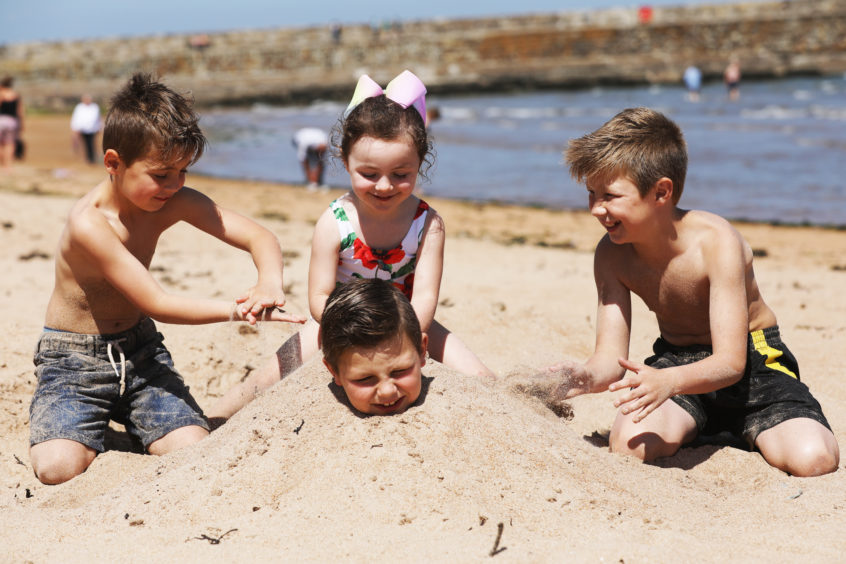 Cousins enjoying the weather on the East Sands, St Andrews. Mhairi Edwards/DCT Media