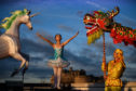 Nina Sun stands beside a unicorn lantern and a Chinese dragon during the launch of the Chinese New Year Edinburgh festival.