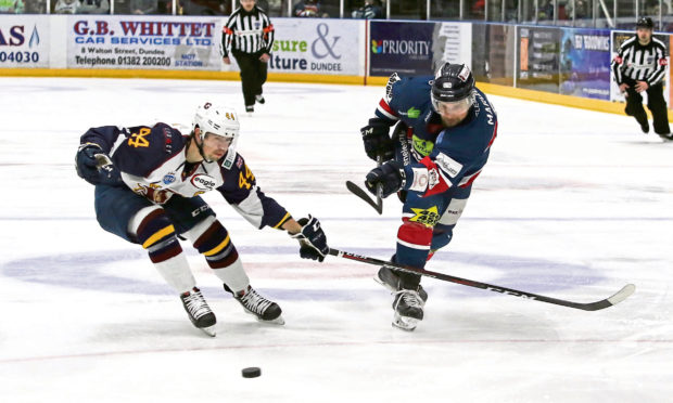 Dundee Stars' Matt Marquardt gets his shot away before Flames Jesse Craige can close him down.