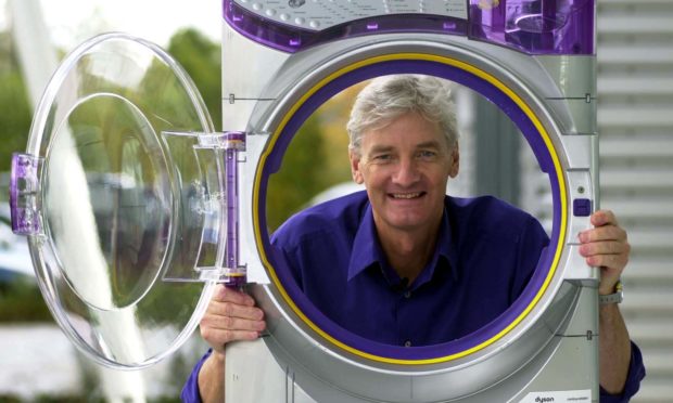 James Dyson with a Dyson Contrarotator washing machine.