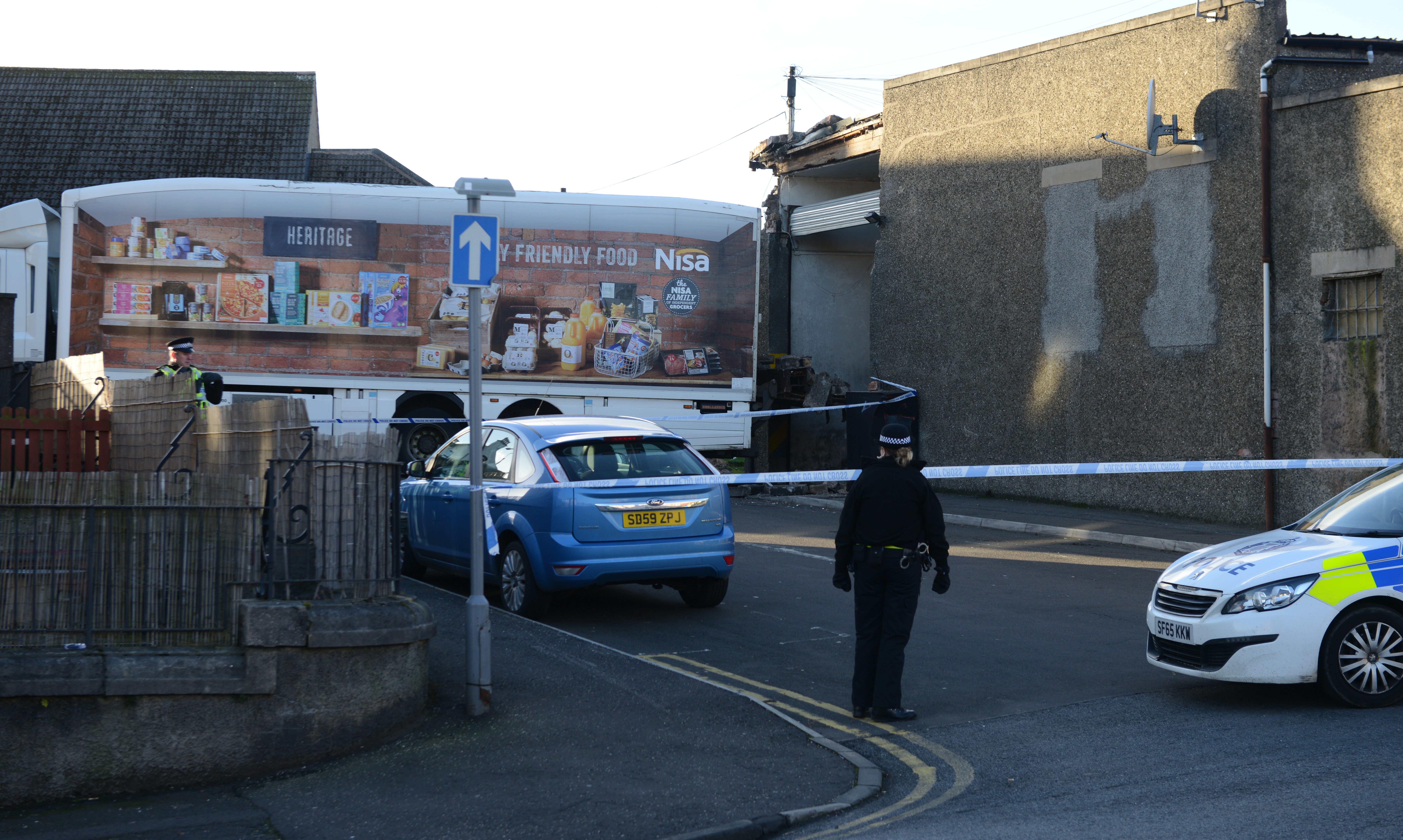 Police seal off the area around the shop after a lorry struck the rear of McColls of Methil.