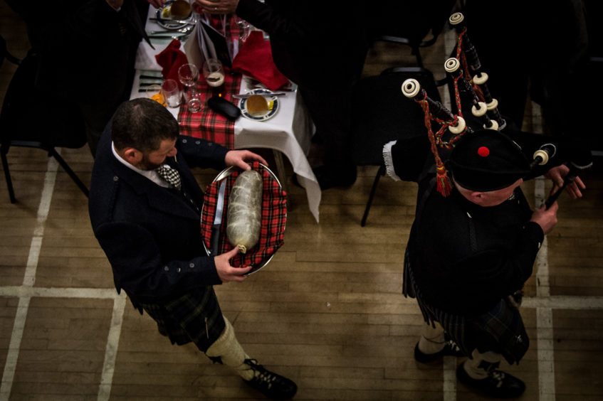 The Haggis making a traditional entrance with piper.