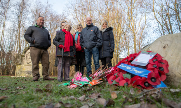 Members of the Finlay family gather to admire the memorial following a Service and rededication ceremony of stone in honour of Fife VC hero David Finlay.