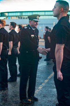 Chief Officer Alasdair Hay congratulates new recruits as they graduate at Thornton