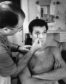 Tony Curtis getting make up applied by Emile LaVigne on the set of "Some Like It Hot" in 1958 in Los Angeles