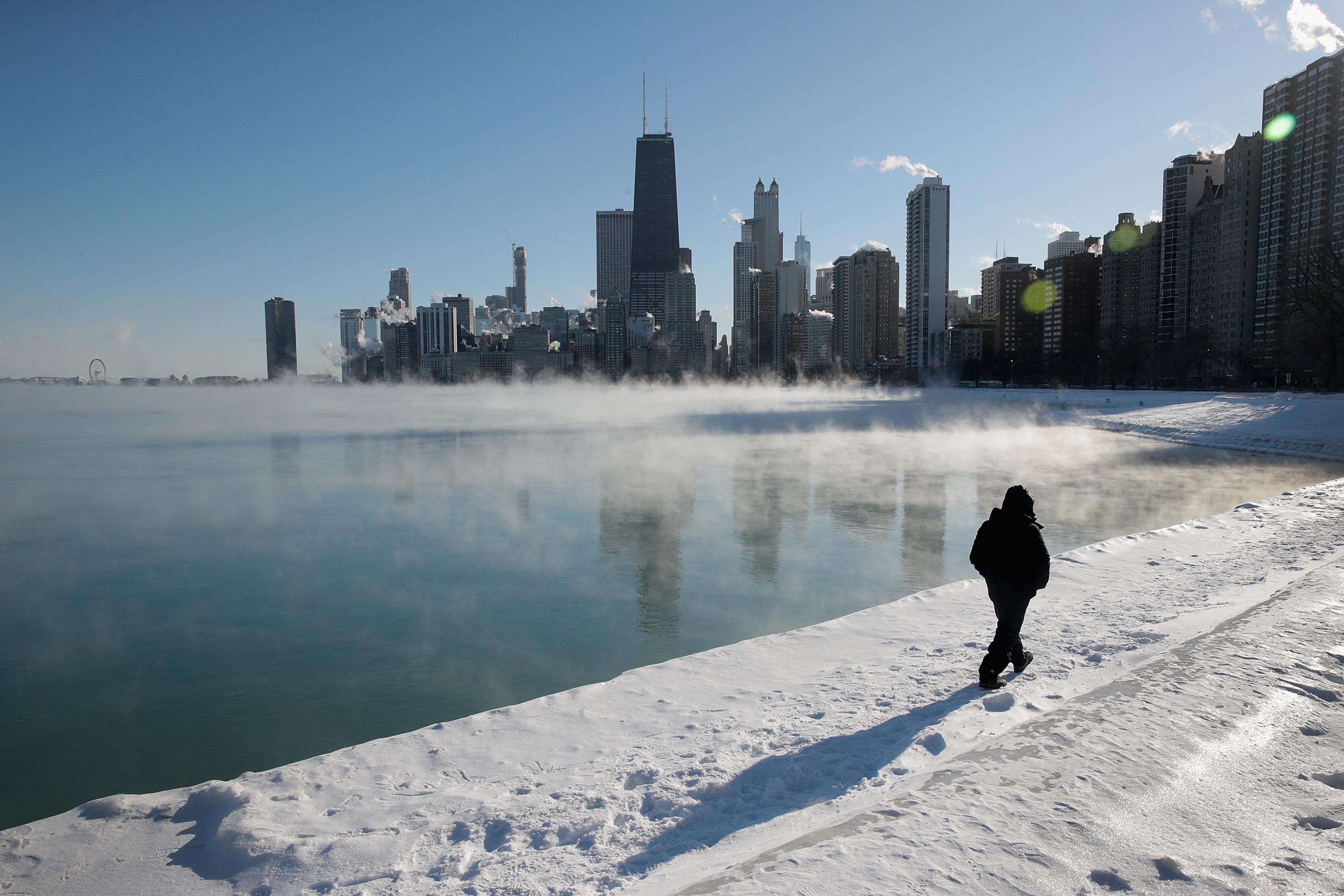 A man takes a walk along the city's lakefront as temperature hung around -20 degrees in Chicago, Illinois. Businesses and schools have closed, Amtrak has suspended service into the city, more than a thousand flights have been cancelled and mail delivery has been suspended as the city copes with record-setting low temperatures.