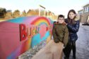 Pupils Lilli-Jane Buchanan and Liam Wood next to the buddy benches.
