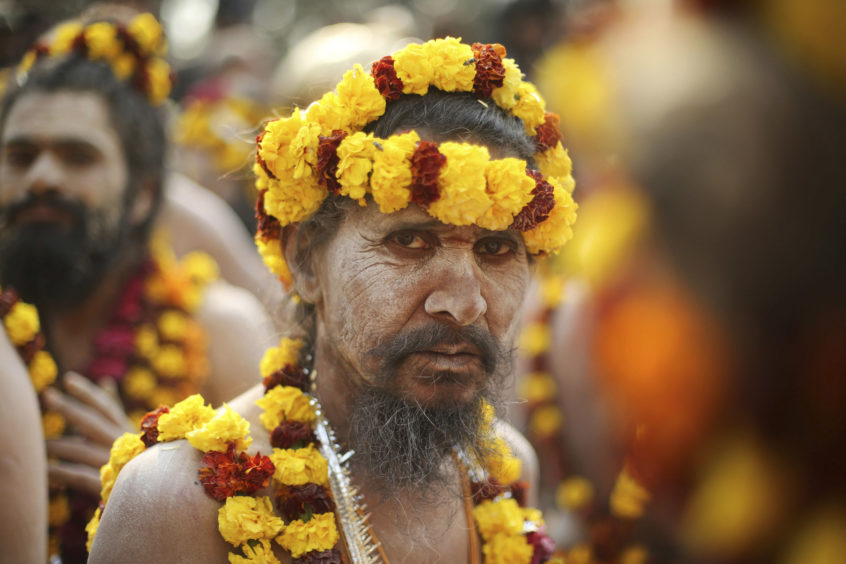Devotees participate in a procession towards the Sangam.
