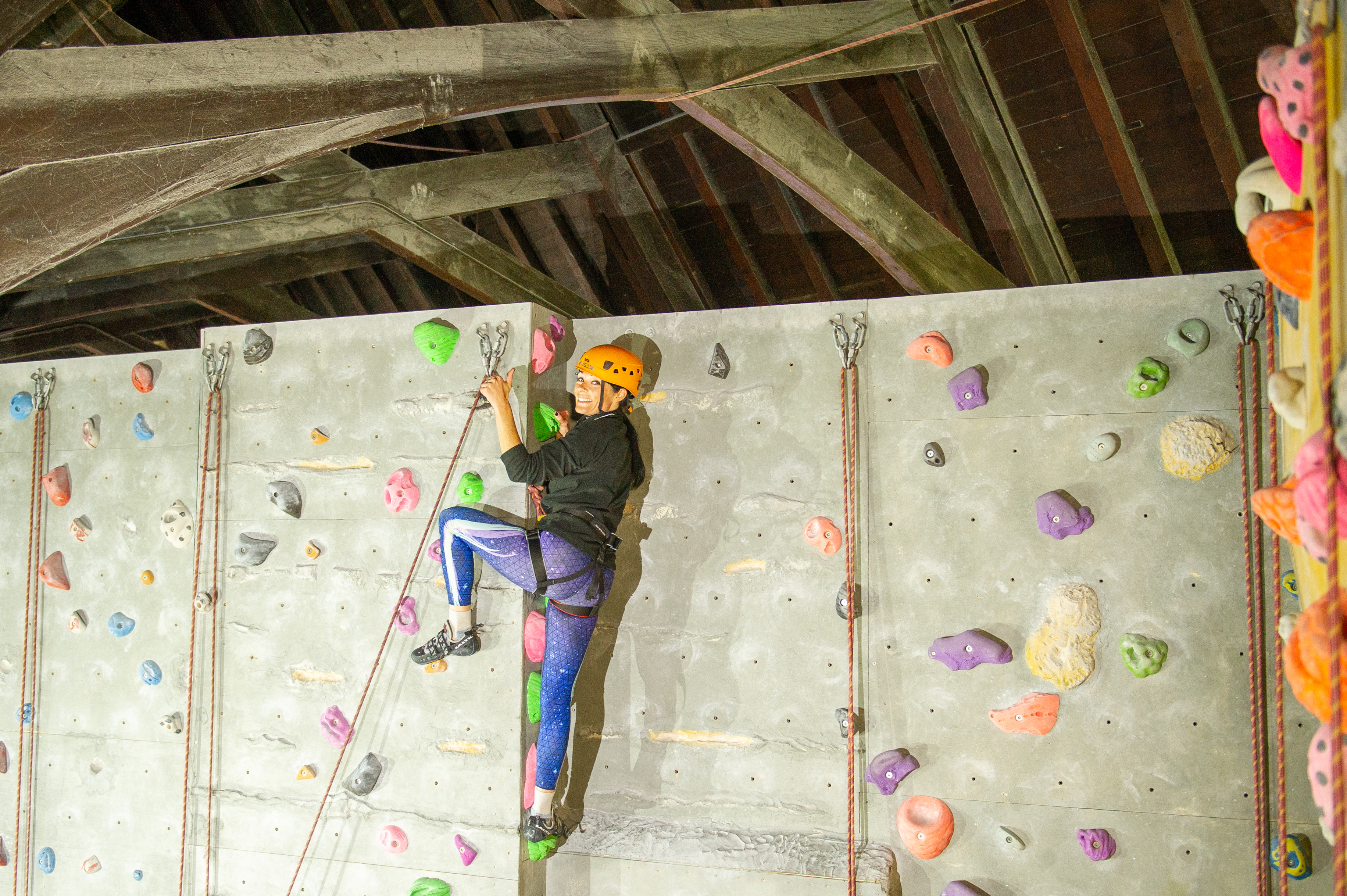 Gayle Ritchie reaches the top of a climbing wall at Avertical World in Dundee.