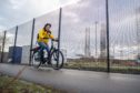 A cyclist using the revamped shared use path through Dundee Port.