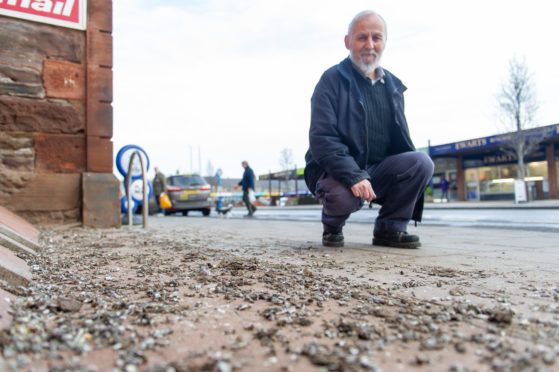 Taxi driver Alex Marshall surveys the mess left by  pigeons on Monifieth High Street.