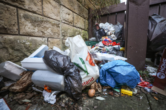 Rubbish has piled up in Dot Murray's garden