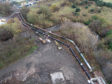 These latest aerial photographs show the new pipe modelling its hardwearing, hand painted, sheer black finish sitting next to its greying older sibling which will soon be put out to pasture. 