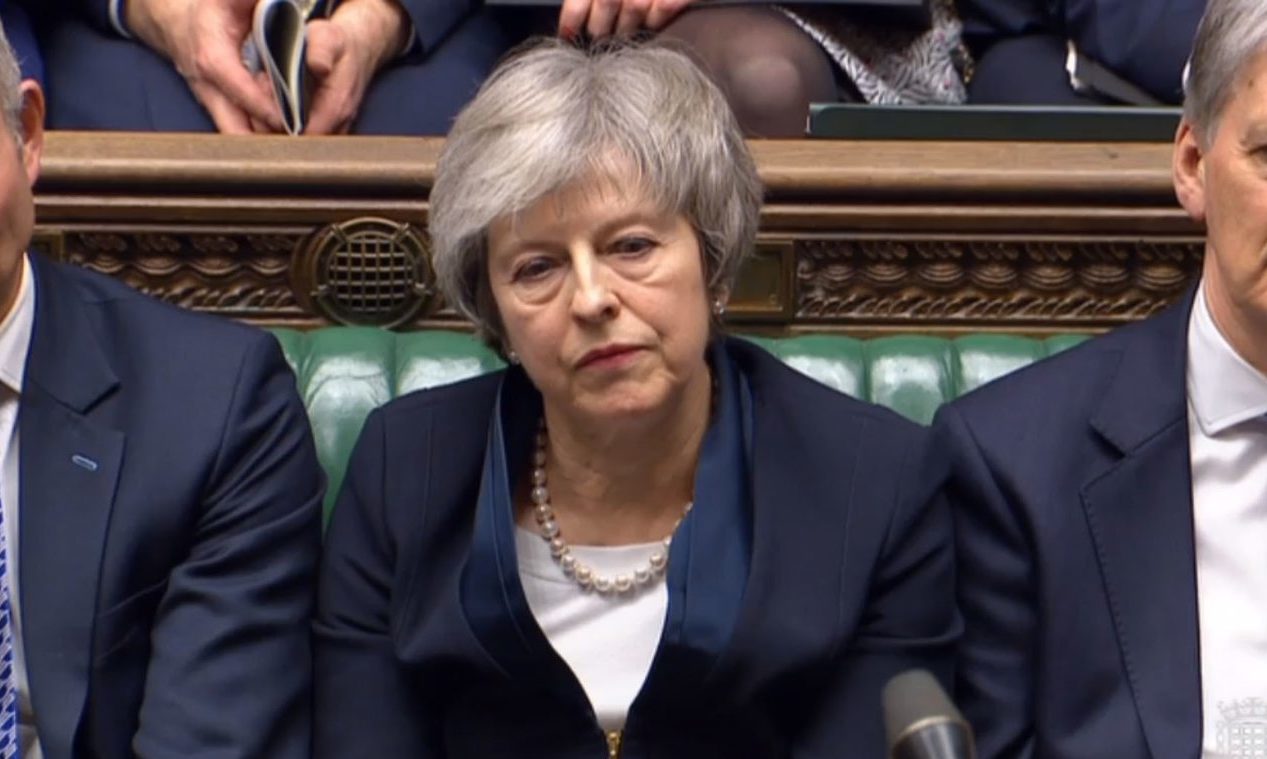 Prime Minister Theresa May listens to Labour leader Jeremy Corbyn speaking after losing a vote on her Brexit deal in the House of Commons, London.