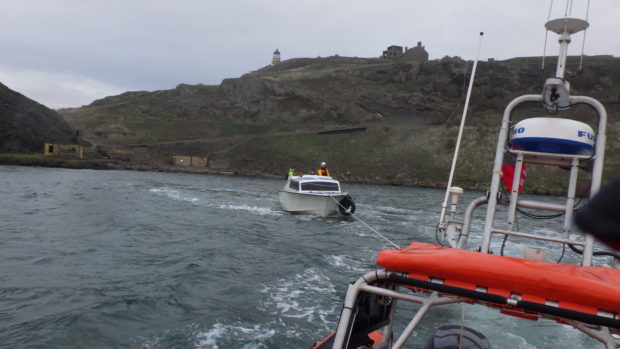 The boat being towed in to safety