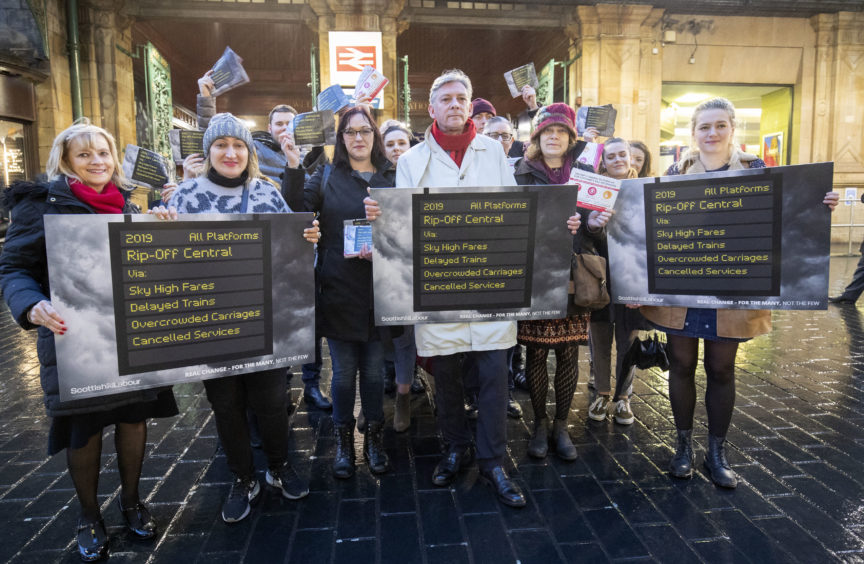 Scottish Labour leader Richard Leonard (centre) alongside union members and TSSA volunteers outside Glasgow's Central Station where he is calling for for public ownership of railways.