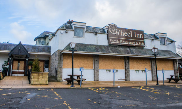 The Wheel Inn, Scone, all boarded up.