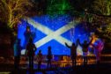 The crowd watch the saltire light show.
