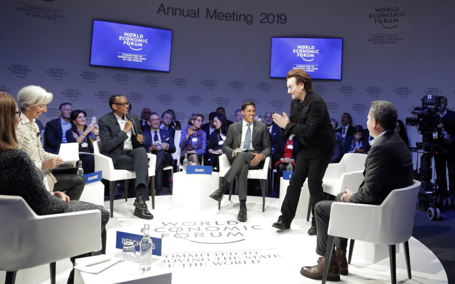 Singer and co-founder of RED Bono, 2nd right, gestures to Afsaneh Mashayekhi Beschloss, founder of RockCreek, Christine Lagarde, Managing Director of IMF and Rwanda President Paul Kagame, from left, as he arrives for the "Closing the Financing Gap" session at the annual meeting of the World Economic Forum in Davos, Switzerland.