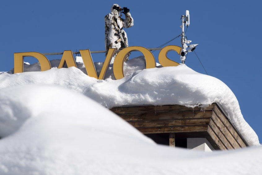 Member of Swiss special police forces stand on the roof of the Kongress Hotel next to the Congress Center.