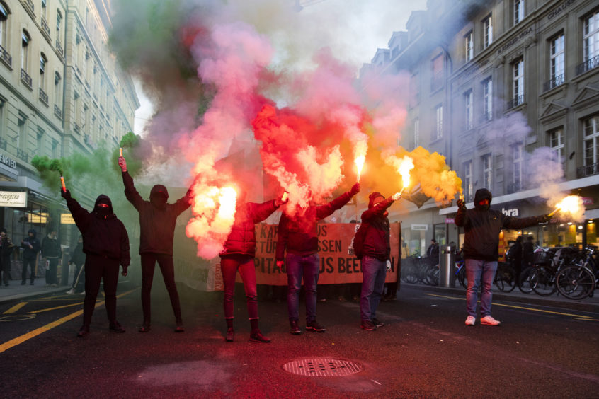 Protesters burn fireworks during a demonstration against the World Economic Forum (WEF) in Bern, Switzerland.