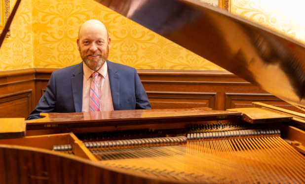 Balbirnie Hotel owner Nicholas Russell with the Baby Grand Piano.