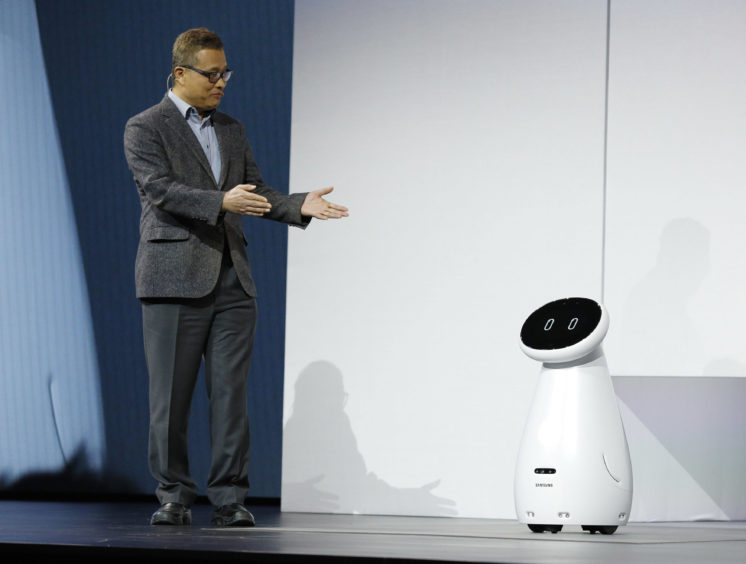 Gary Lee, senior vice president and head of the AI Center at Samsung Electronics, unveils the Bot Care robot.